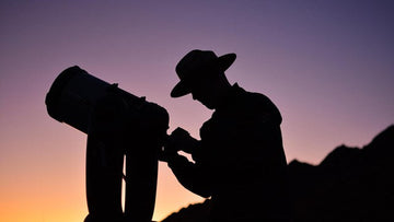 National Park Ranger setting up a telescope at dusk
