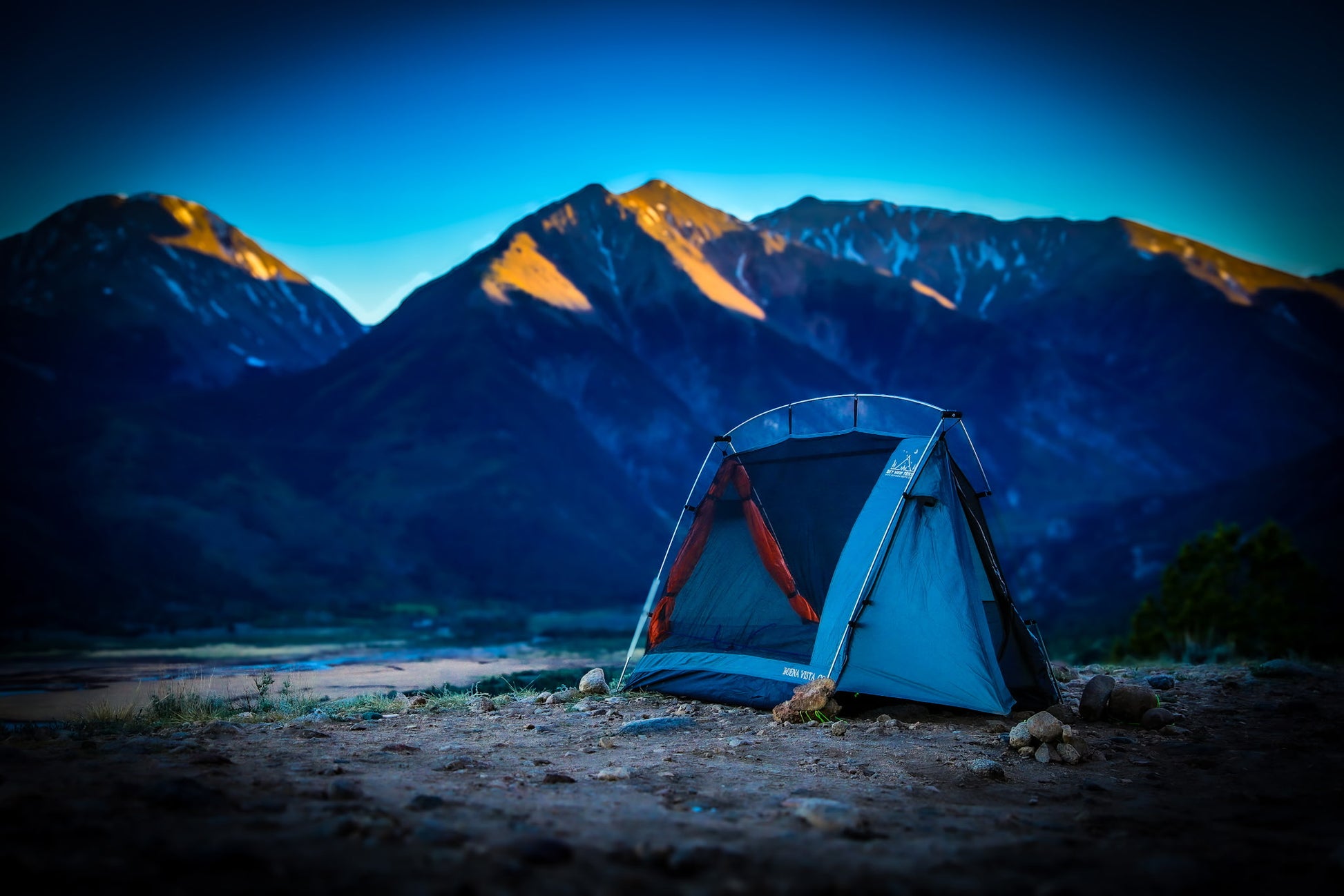 Stargazing Camping tent at dust surrounded by mountains.
