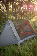 camping targazing tent with person inside smiling